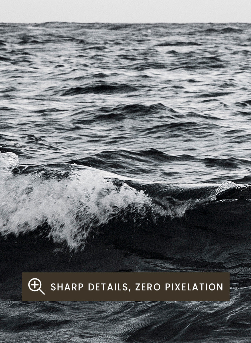 Black and white photographic art print of ocean waves under a cloudy sky. Endless Waves by Shot by Clint black-and-white ocean photography print featuring rolling water, textured surf, cloudy skies, and dramatic coastal movement.
