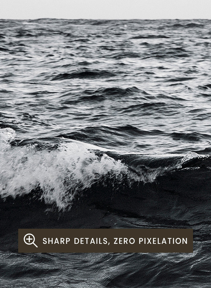 Black and white photographic art print of ocean waves under a cloudy sky. Endless Waves by Shot by Clint black-and-white ocean photography print featuring rolling water, textured surf, cloudy skies, and dramatic coastal movement.
