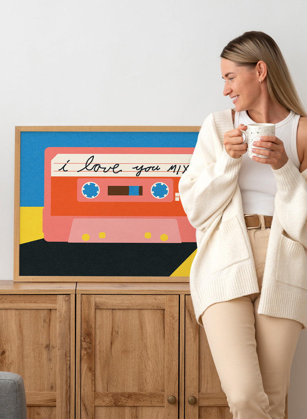 Illustration of a cassette tape with 'I love you mix' text on a blue and yellow background. I Love You Mix Tape by Rosi Feist is a bold pop art print of a retro cassette with a handwritten love note. Officially licensed wall poster with framing.