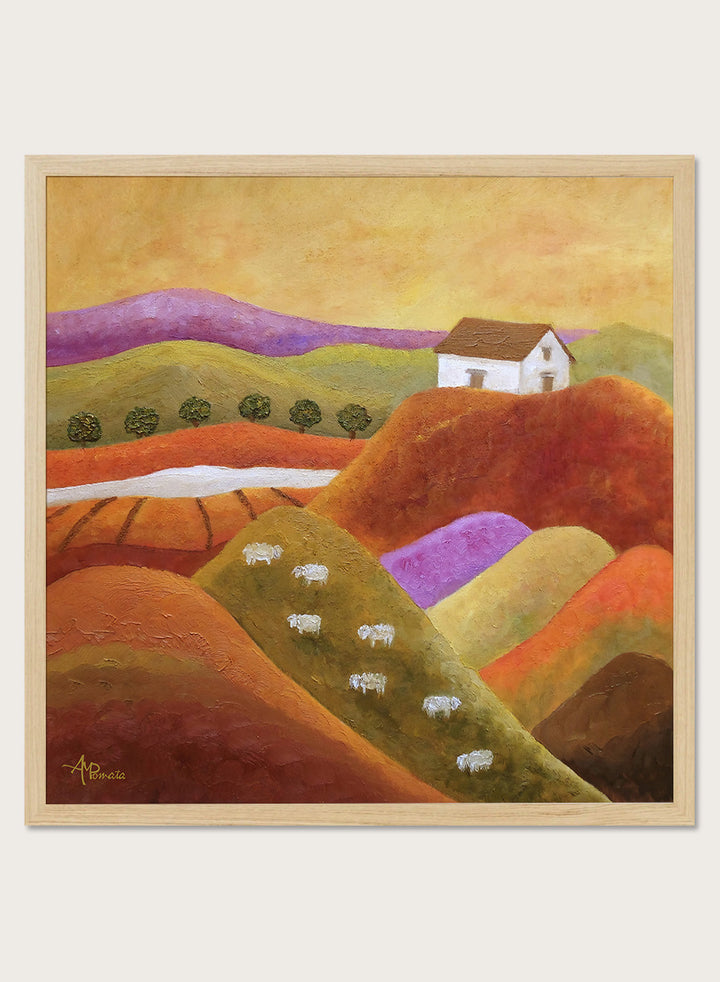 A framed landscape painting featuring rolling hills in warm earth tones, purple and green valleys, a small white house, and white sheep. Shop Pastoral Hills With Sheep by Angeles M. Pomata, an autumn countryside art print featuring rolling hills, grazing sheep, a white farmhouse, and warm earthy tones.