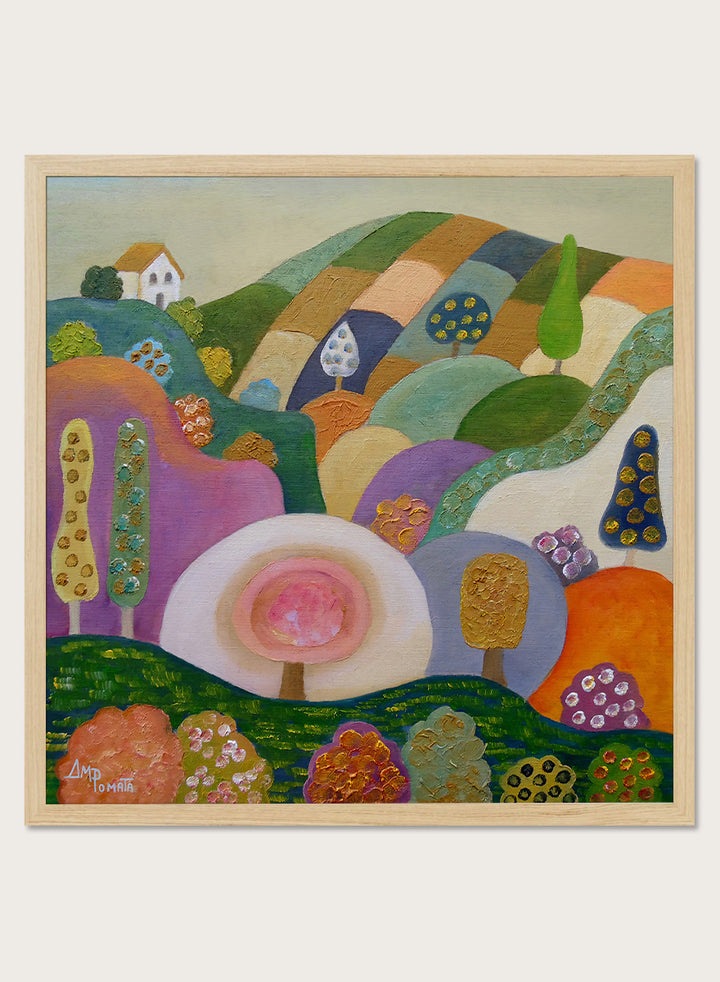 A colorful abstract landscape painting in a black frame, featuring stylized hills, trees, flowers, and a small house. The artwork has a playful, patchwork-like design with multiple vibrant colors including green, purple, orange, pink, blue, and yellow, set against a light beige wall. Shop Whimsical Hillside Village by Ángeles M. Pomata, a colorful landscape art print with rolling hills, patterned trees, and a dreamy village feel.