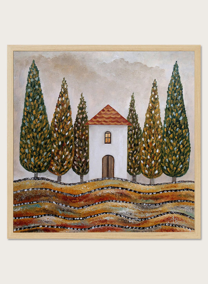A framed landscape art print depicting a small white house with a red-tiled roof, surrounded by tall green cypress trees and wavy golden-brown hills. Shop Tuscan Cypress House by Angeles M. Pomata, an autumn landscape art print featuring a white country house, tall cypress trees, terracotta roof, and warm earthy tones.