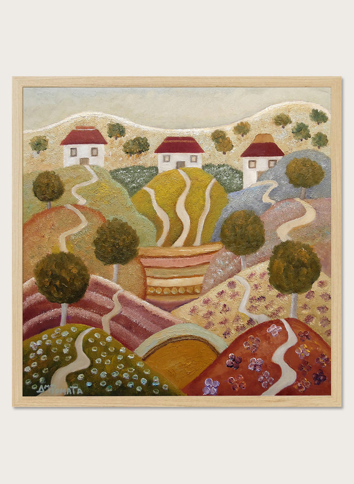 A framed landscape painting featuring stylized rolling hills, winding paths, small houses with red roofs, and trees. Shop Charming Hillside Village by Angeles M. Pomata, a colorful countryside art print featuring winding paths, red-roof houses, flowering fields, and warm autumn tones.