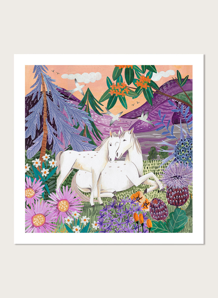 Framed artwork of two horses in a colorful forest scene with flowers and mountains. Horses in the Mountains by Caroline Bonne Müller is a fine art print and wall poster featuring two white horses surrounded by colorful flowers in a mountain landscape.