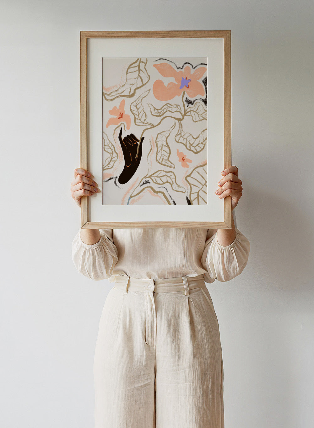 Abstract artwork with a black hand reaching towards flowers on a light background. Fleur by Arty Guava is a modern floral art print with soft abstract flowers and hand-drawn linework. Officially licensed wall poster with framing.