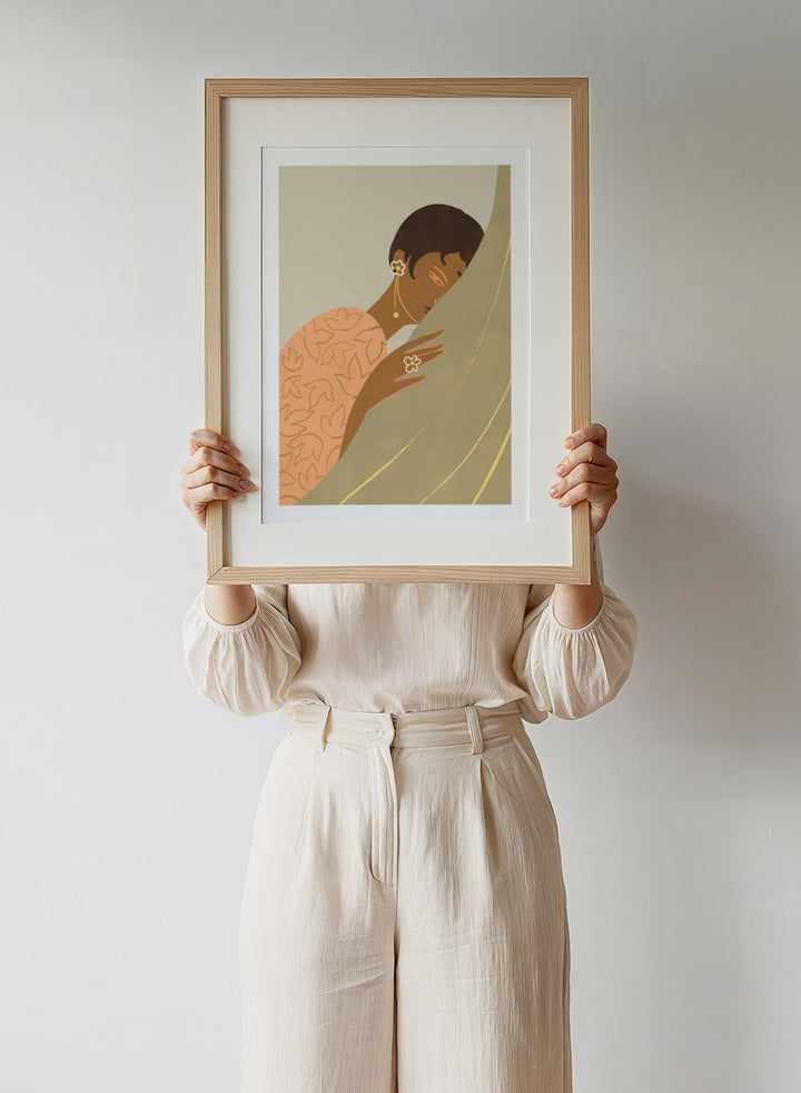 Illustration of a woman wrapped in a floral-patterned shawl with a neutral background. The Introvert by Arty Guava is a modern portrait illustration featuring a woman figure, soft color palette, contemporary wall art style, and officially licensed artwork.