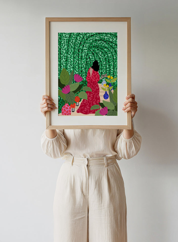 Girl at Her Garden by Rafaela Mascaro fine art print featuring lush green botanical background, red dress figure, and modern contemporary wall art poster.