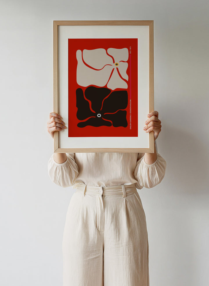 Abstract design with beige and black shapes on a red background. Two By Two Flower Red by Frances Collett is a modern abstract floral art print featuring two bold flowers in red, black, and cream tones. Officially licensed wall poster with optional framing.