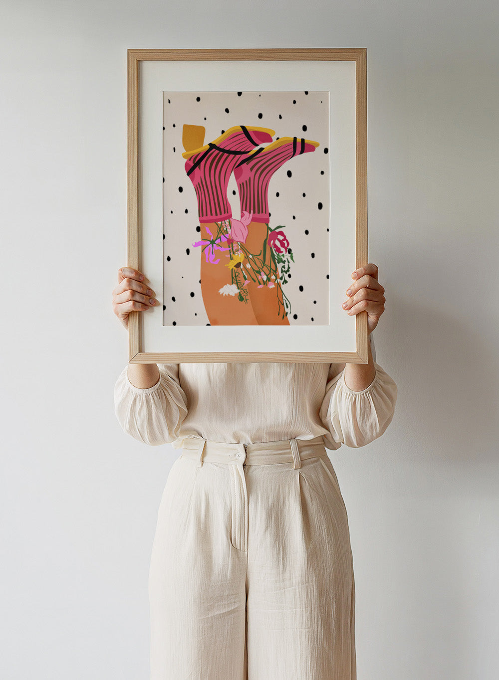 Illustration of a person wearing a pink top with floral accessories on a polka dot background. Floral Step Delight by Gauri Mokate is an officially licensed art print featuring a fashion-inspired illustration with florals, bold colors, and modern graphic style.