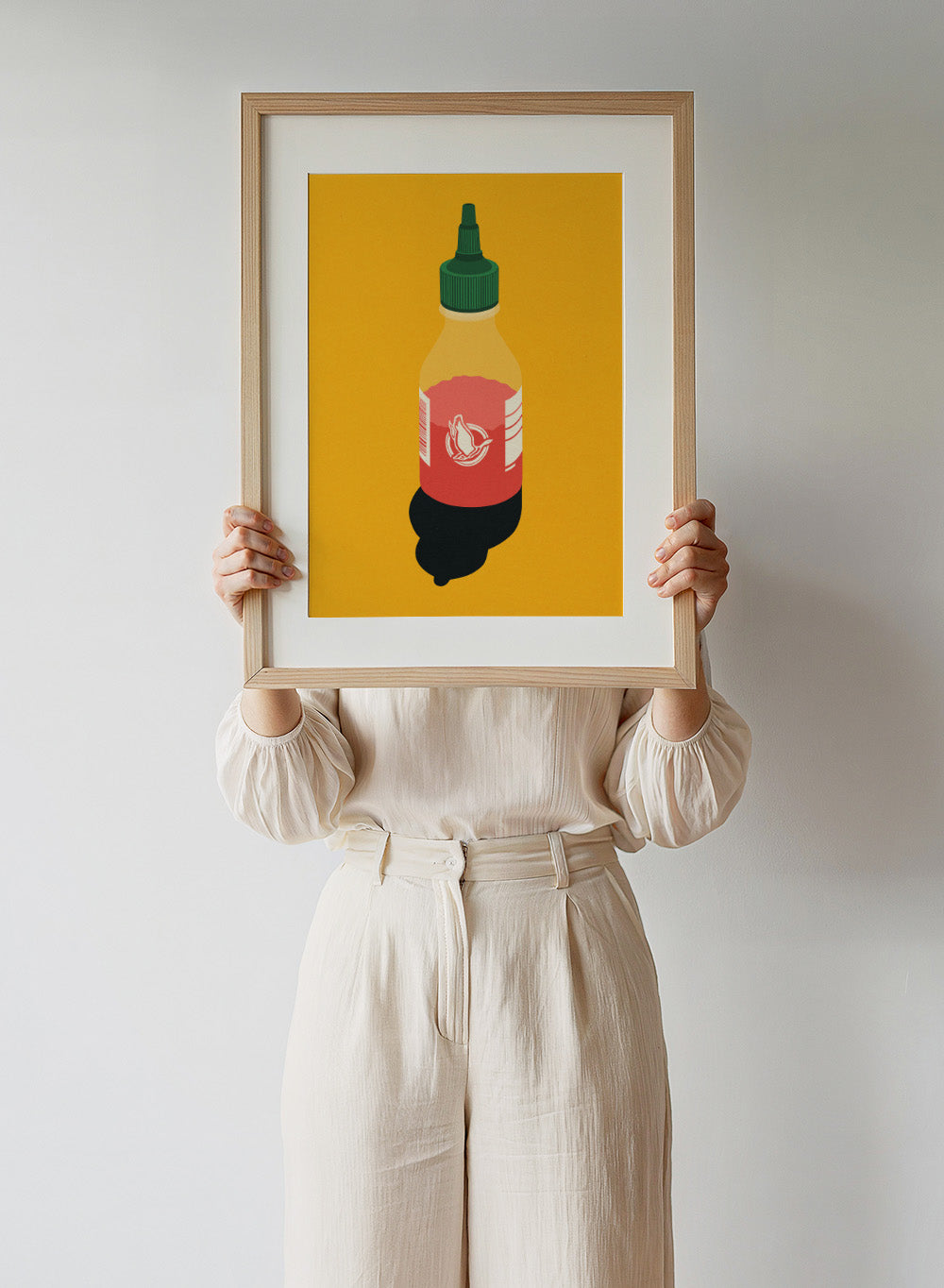 Chilli sauce bottle illustration on a yellow background. Chilli Sauce by Rosi Feist is a bold kitchen art print featuring a hot sauce bottle in modern graphic style. Contemporary food poster wall art.