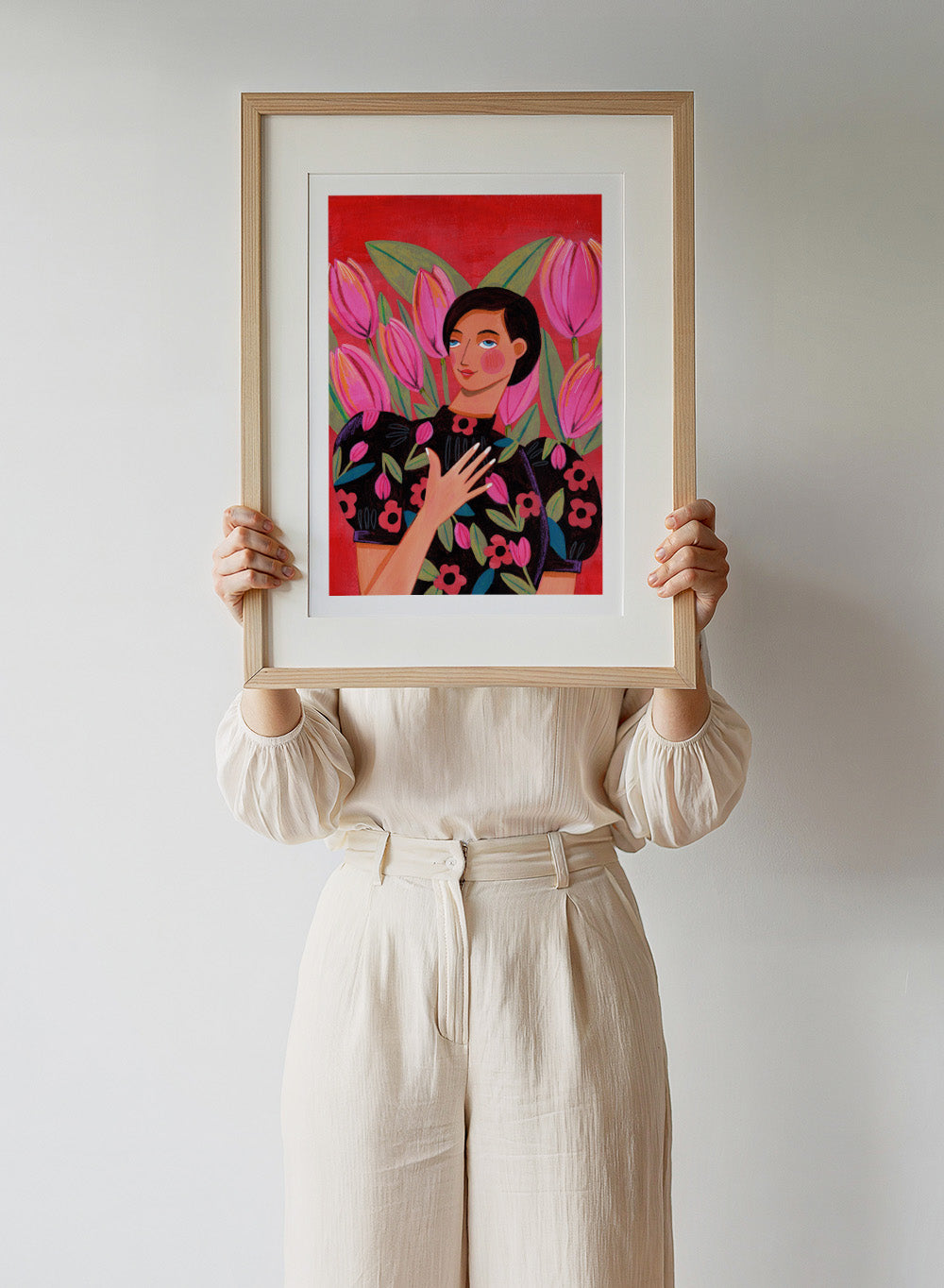 Illustration of a woman with floral dress and pink tulips on a red background. Woman portrait art print surrounded by pink tulips on a red background by Caroline Bonne Müller. Colorful floral illustration wall poster, officially licensed.