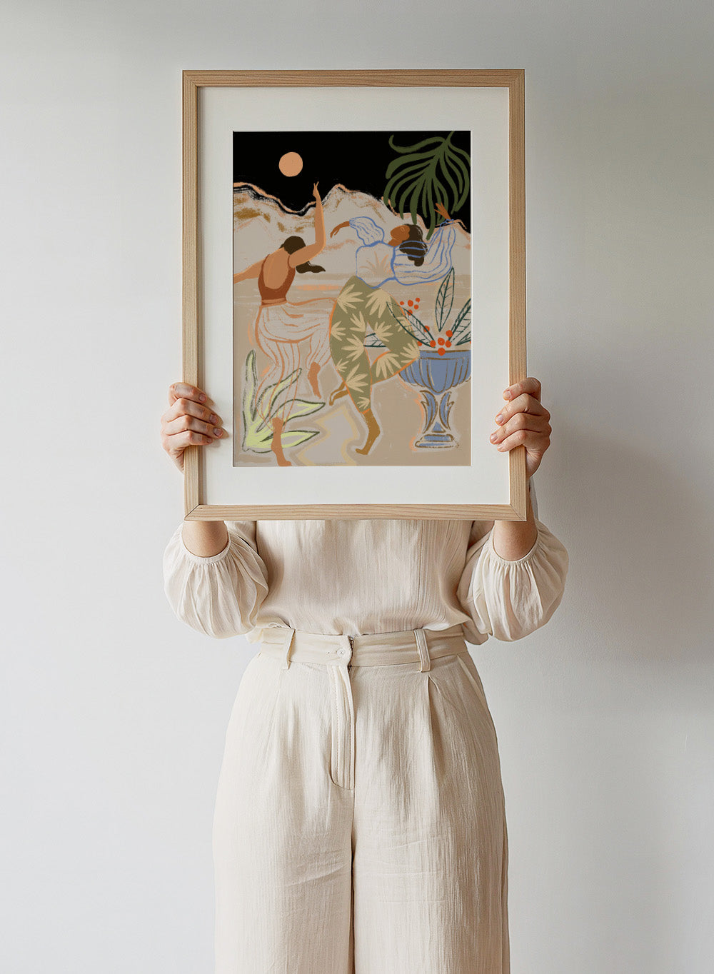 Artistic depiction of two figures dancing with plants and a vase in the background. Moonlight Dance by Arty Guava is a modern illustration art print featuring dancing women, moon imagery, floral elements, and contemporary wall art design.