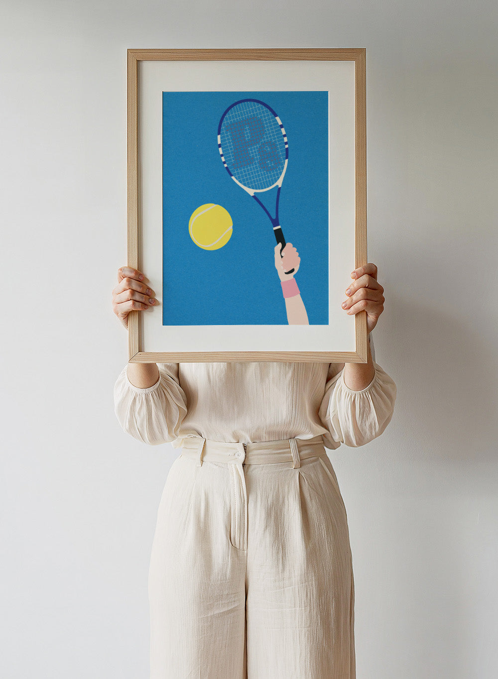 Tennis racket and ball on a blue background. Perfect Serve by Rosi Feist is a modern minimalist tennis art print featuring bold graphic color, clean lines, and Bauhaus-inspired design. Officially licensed fine art poster with framing.