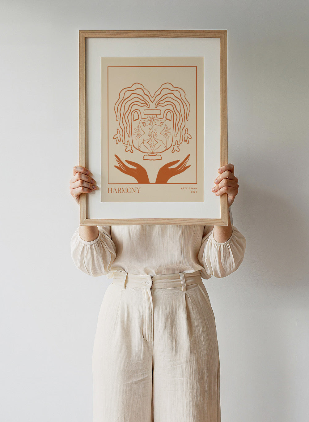 Artistic illustration of a heart with hands holding it, titled 'Harmony' by Arty Guava 2024. Harmony by Arty Guava is a minimalist vessel art print with terracotta linework, mirrored figures, and symbolic calm. Officially licensed wall poster.