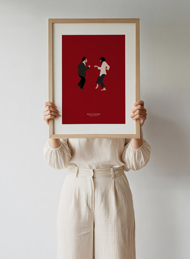Minimalist illustration of two characters facing each other on a red background with 'Pulp Fiction' text. Minimalist dance illustration of two figures on a red background by Anne-Marie Volfova. Officially licensed modern art print with optional framing.