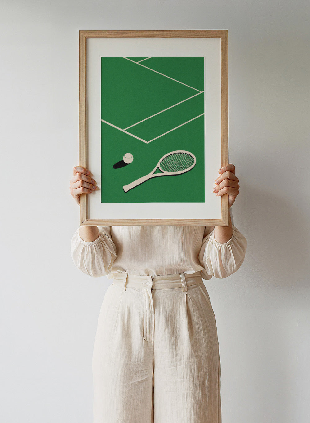 Tennis racket and ball on a green court with white lines. Lawn Tennis Club by Rosi Feist is a minimalist tennis court art print with modern Bauhaus design. Officially licensed fine art poster with framing.