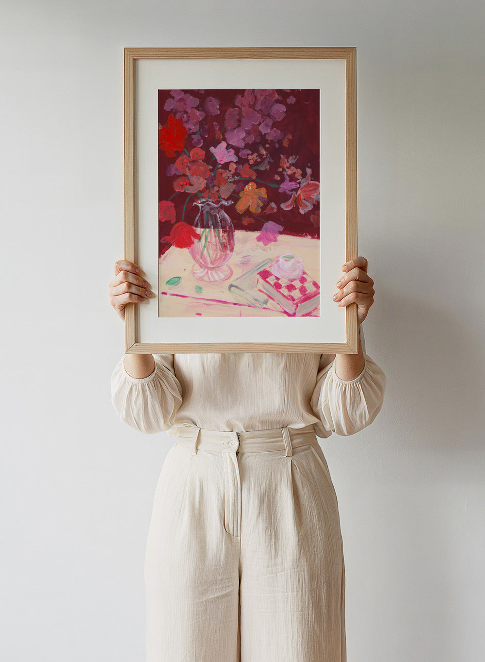 Colorful still life painting with flowers and a teacup on a table. Fall Bouquet by Katharina Puritscher art print featuring expressive floral still life, glass vase, coffee cup, book, and brushstrokes. Officially licensed wall poster.