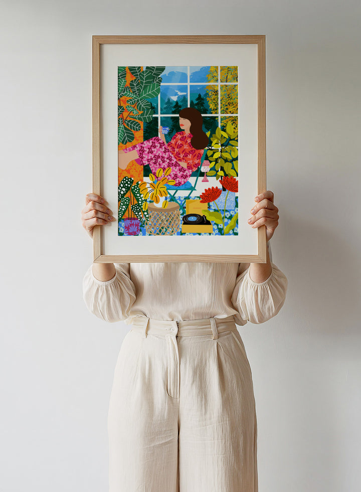 Illustration of a woman sitting by a window with a cup, surrounded by plants and flowers. Listening To the Sound of Nature by Rafaela Mascaro fine art print featuring woman by window, botanical interior, colorful plants, modern contemporary wall art poster.