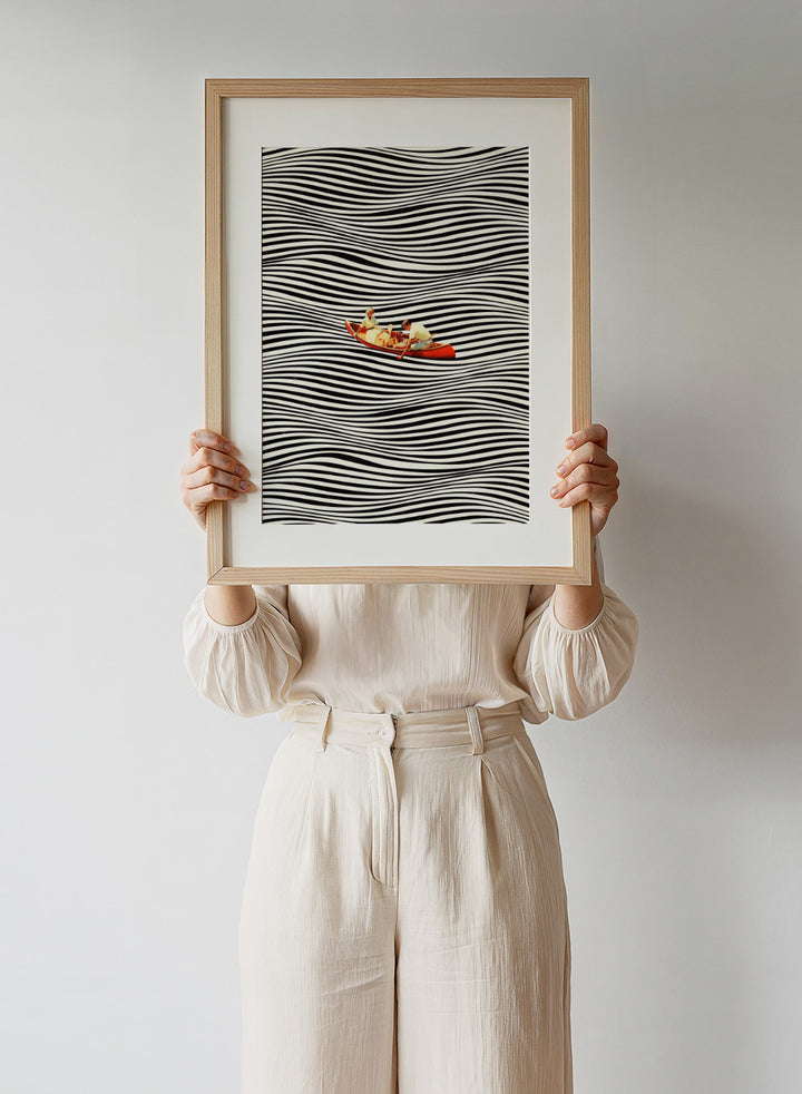 Two people in a red boat on a background of black and white wavy lines. The Real Boat Trip by Taudalpoi features a surreal boat illustration floating on black and white wavy lines. Retro collage art print with optical illusion design and optional framing.