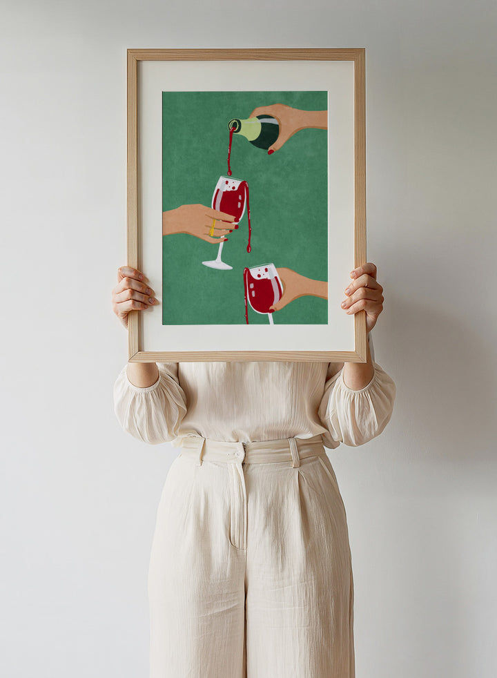 Illustration of hands pouring red wine into glasses on a green background. Cheers Girls by Raissa Oltmanns is a modern wine art print featuring bold red glasses and contemporary girl dinner party wall poster style.