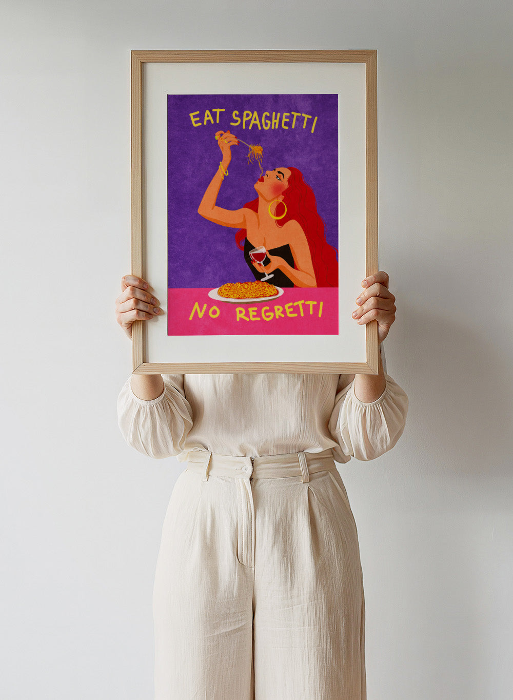 Illustration of a woman eating spaghetti with text 'Eat Spaghetti No Regretti' on a purple and pink background. Eat Spaghetti No Regretti by Raissa Oltmanns is a modern kitchen art print featuring a woman eating pasta, wine illustration, and funny food wall poster.
