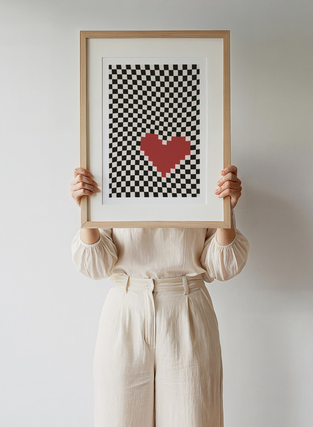 Checkered pattern with a red heart in the center. Pixel Heart by Frankie Kerr-Dineen features a red pixel heart on a wavy checkerboard background. Modern graphic art print and contemporary wall poster.