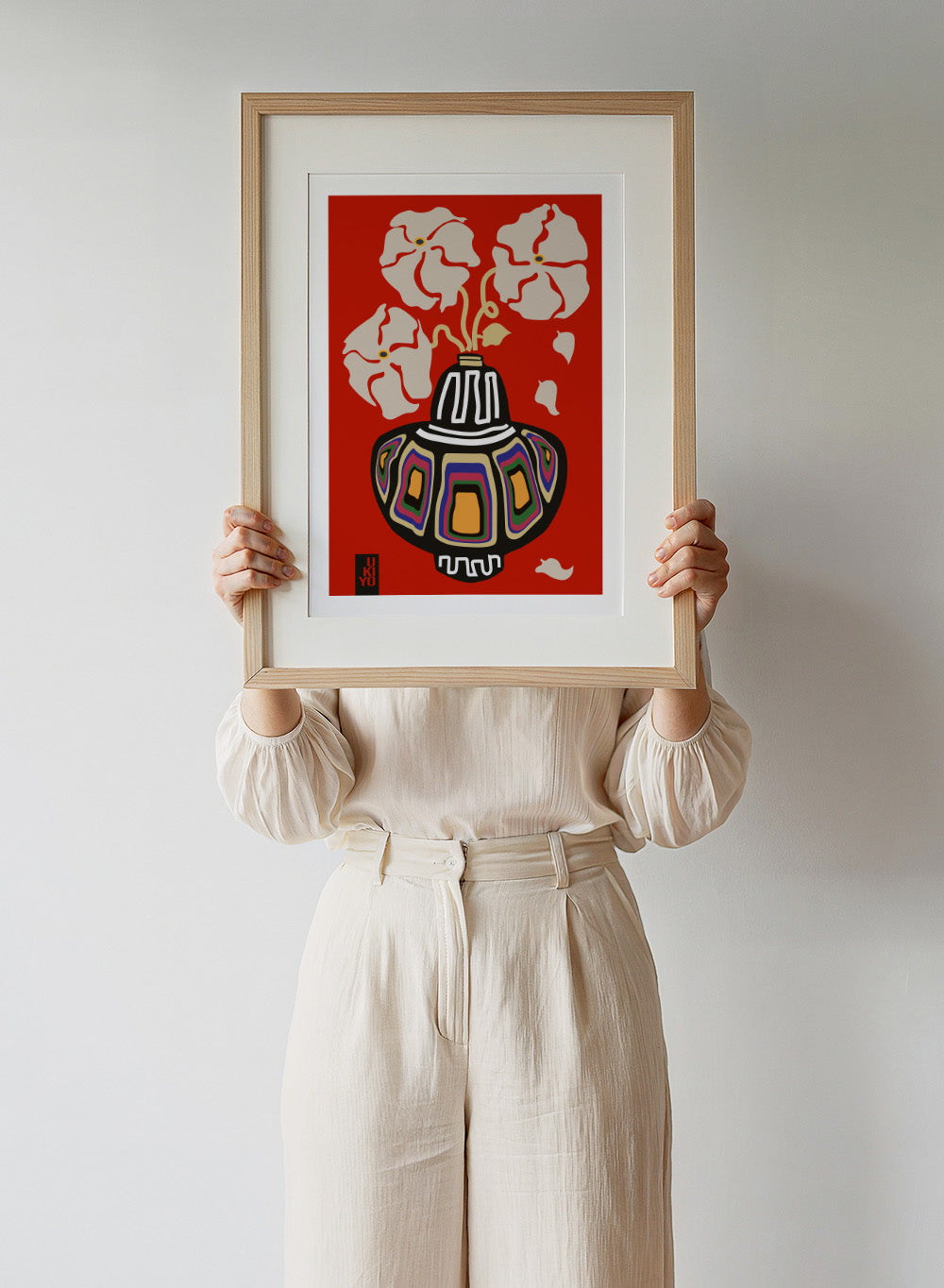 Decorative vase with colorful patterns on a red background. Ukiyo Vase Flower Rainbow Red by Frances Collett art print featuring a colorful patterned vase with cream flowers on a red background. Officially licensed wall poster with optional framing.