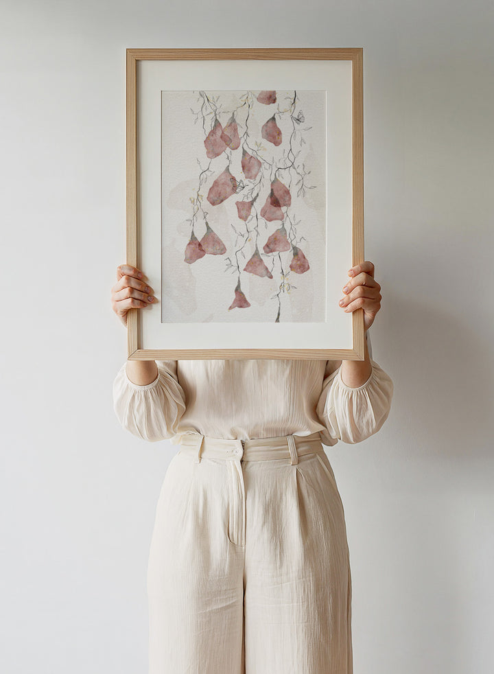 Artistic depiction of pink flowers and branches on a light background. Butterfly Kisses by Ankie Kooi features hanging watercolor flowers, delicate branches, and butterflies in soft neutral tones. Minimal botanical art print inspired by nature.