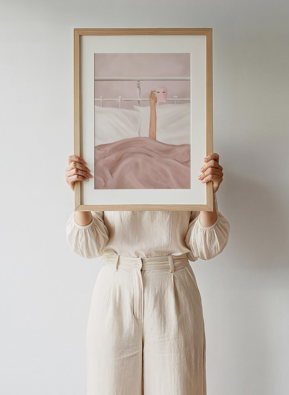Coffee Cup by Flow Line is a cozy morning art print featuring a woman in bed holding a pink mug. A modern lifestyle wall poster celebrating slow mornings.