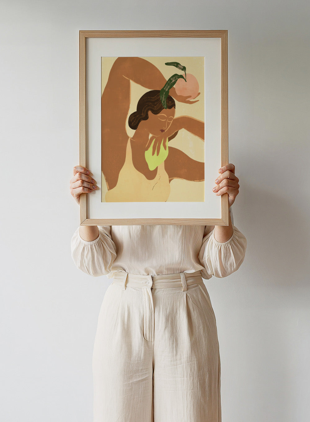 Artistic depiction of a woman with abstract elements on a beige background. Lemon Apple by Arty Guava art print, modern woman and fruit illustration, contemporary aesthetic wall poster in warm yellow and soft green tones.