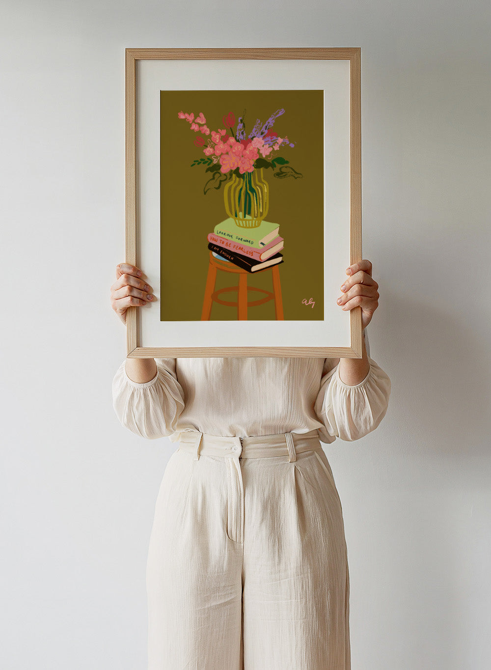 Vase with flowers on a stack of books on a stool against a green background. Floral Vase by Arty Guava is a modern flower still life art print with a striped vase and book stack. Officially licensed wall poster.