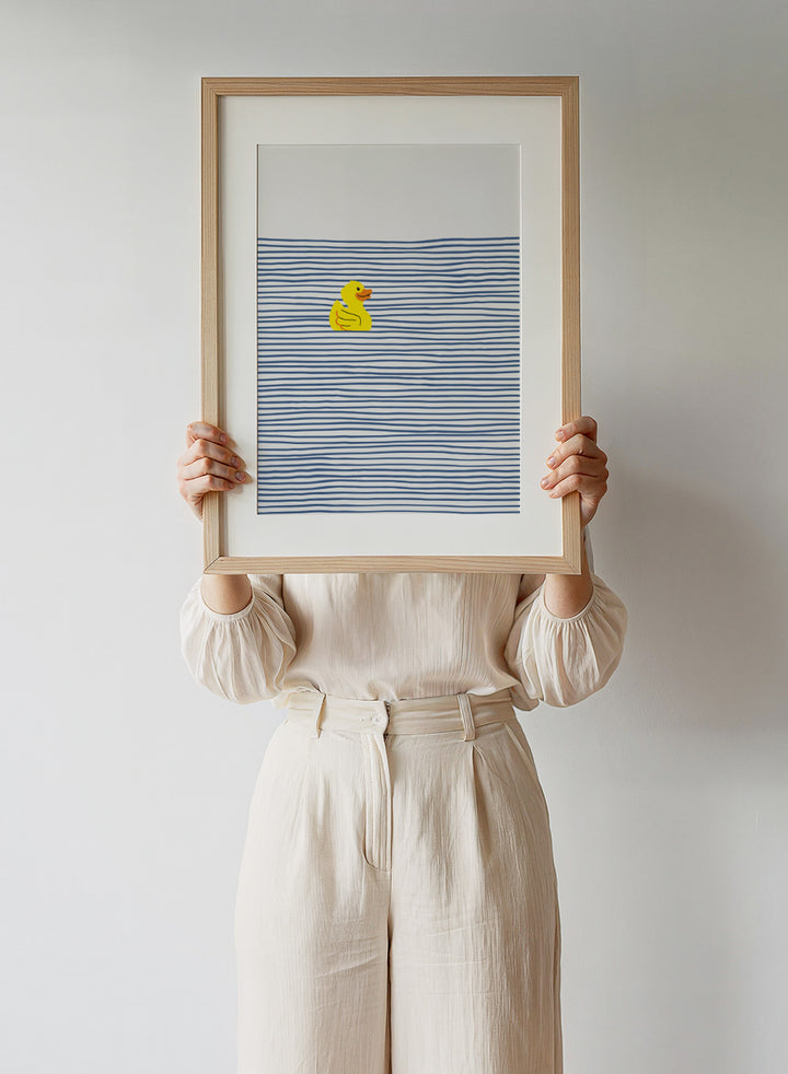 Yellow Duck Afloat art print by Little Dean. Playful duck illustration with blue ocean stripes, modern minimalist wall art, contemporary poster design.