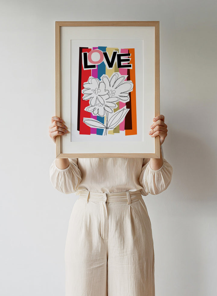 Colorful abstract design with flowers and the word 'LOVE' on a striped background. Scribble Flower by Frances Collett art print featuring a hand-drawn flower over bold colorful stripes with the word LOVE. Officially licensed wall poster with framing option.