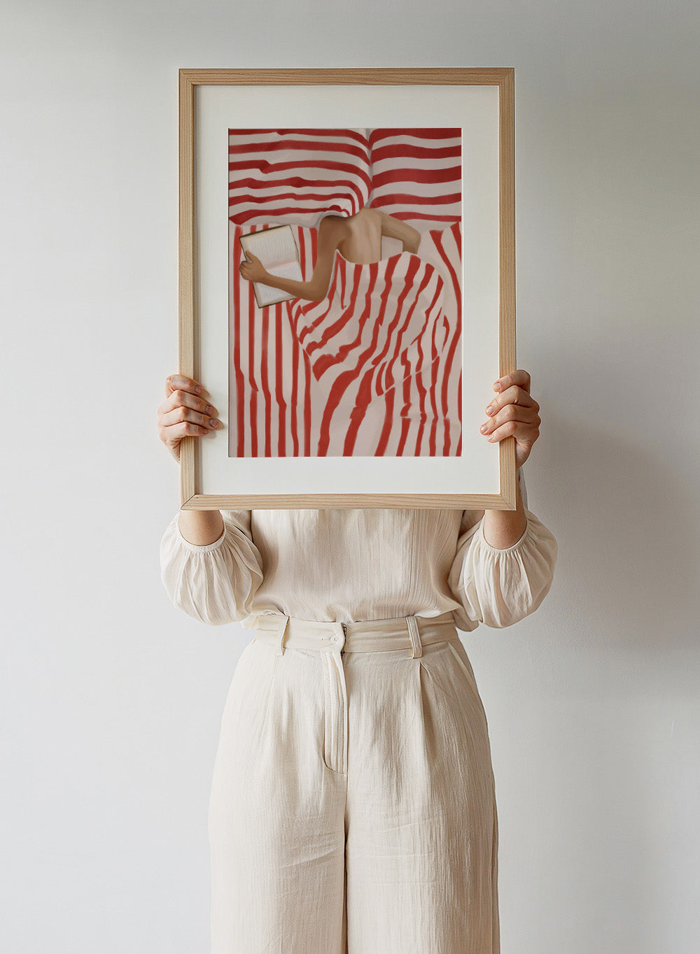 Between the Lines by Flow Line art print shows a woman reading in bed wrapped in red striped bedding. A modern lifestyle wall poster inspired by slow evenings.