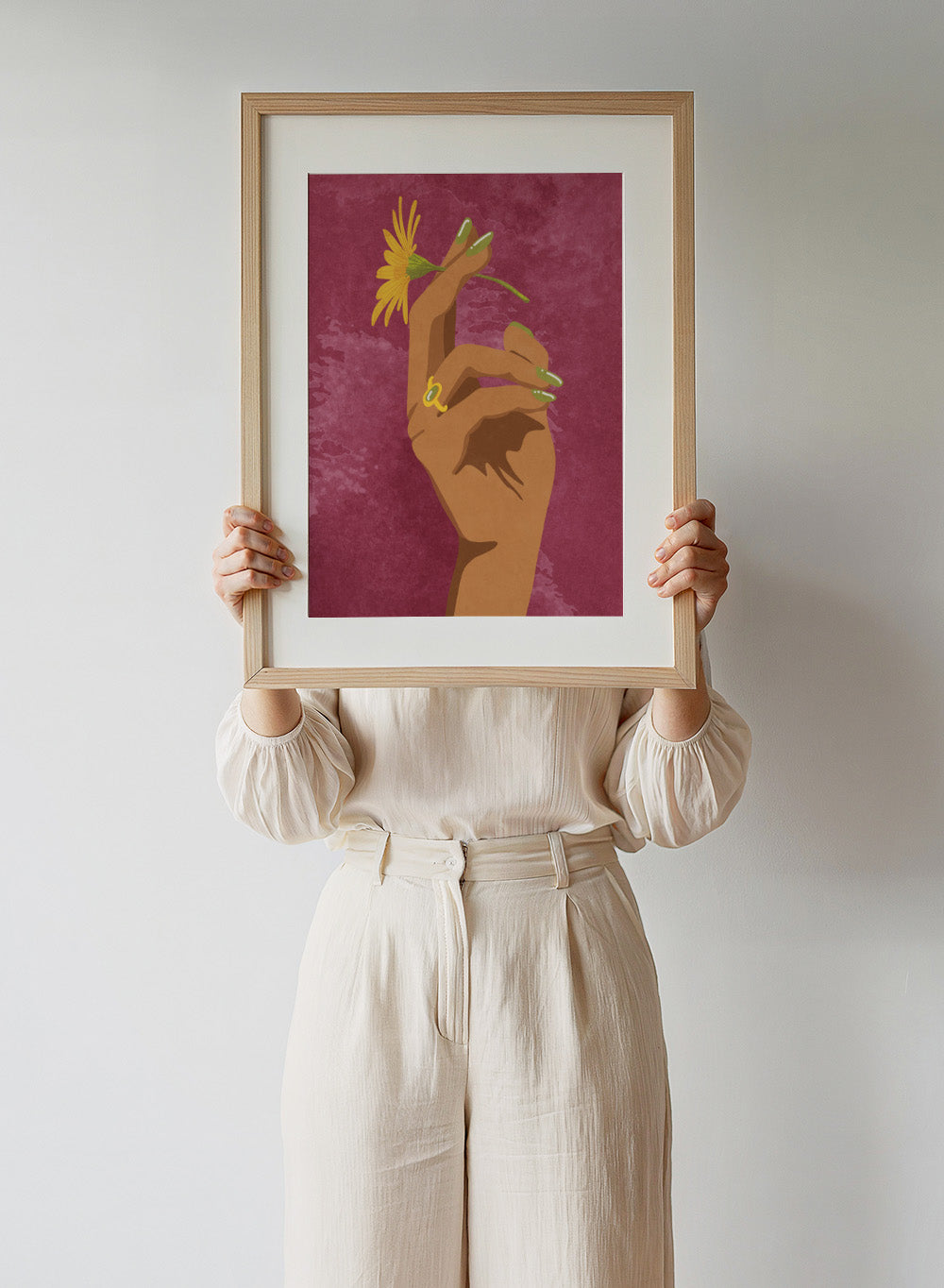Illustration of a hand holding a yellow flower against a pink background. Smoking Flower by Raissa Oltmanns is a modern floral art print featuring a hand holding a yellow flower in bold contemporary wall poster style.