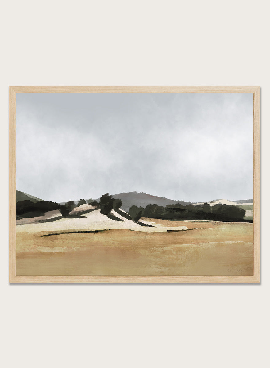 Shop Lazy Afternoon by Dan Hobday, a warm landscape art print featuring golden fields, dark trees, rolling hills, and soft late-summer tones.