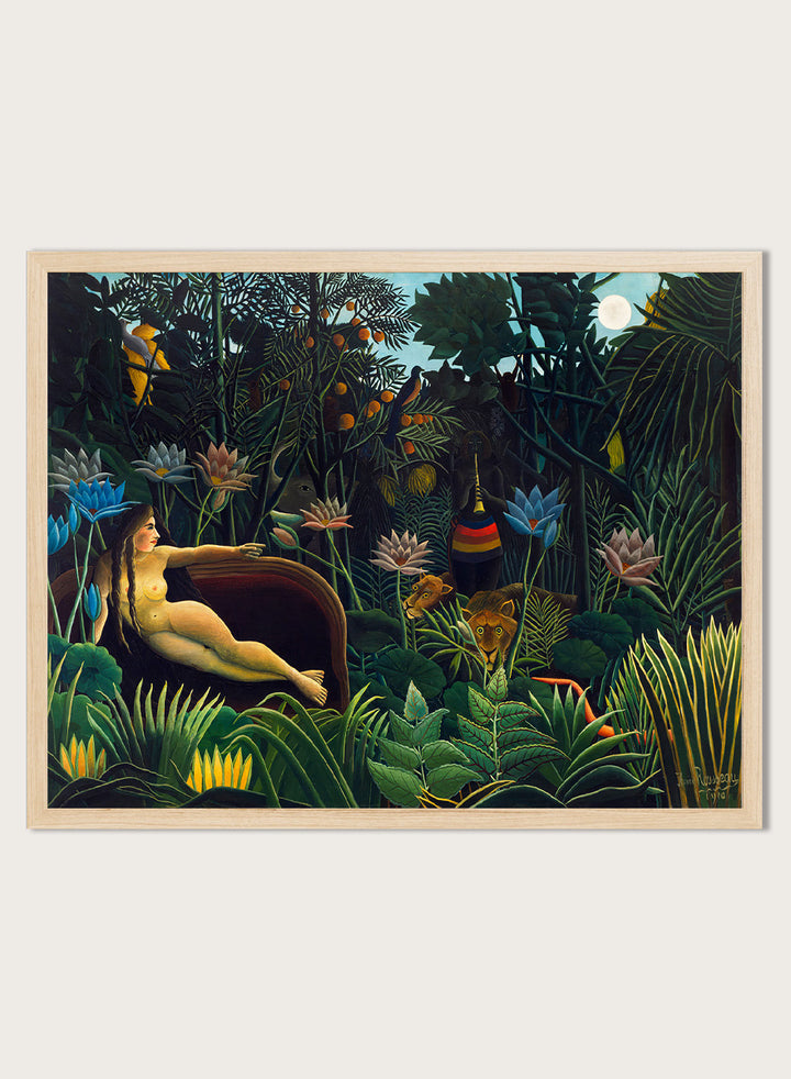 A framed art print depicting a lush, surreal jungle scene with a reclining nude woman in a boat, colorful flowers, birds, and animals under a full moon. The Dream by Henri Rousseau is a vintage jungle art print featuring a reclining woman, lush tropical plants, lions, flowers, and a moonlit forest.