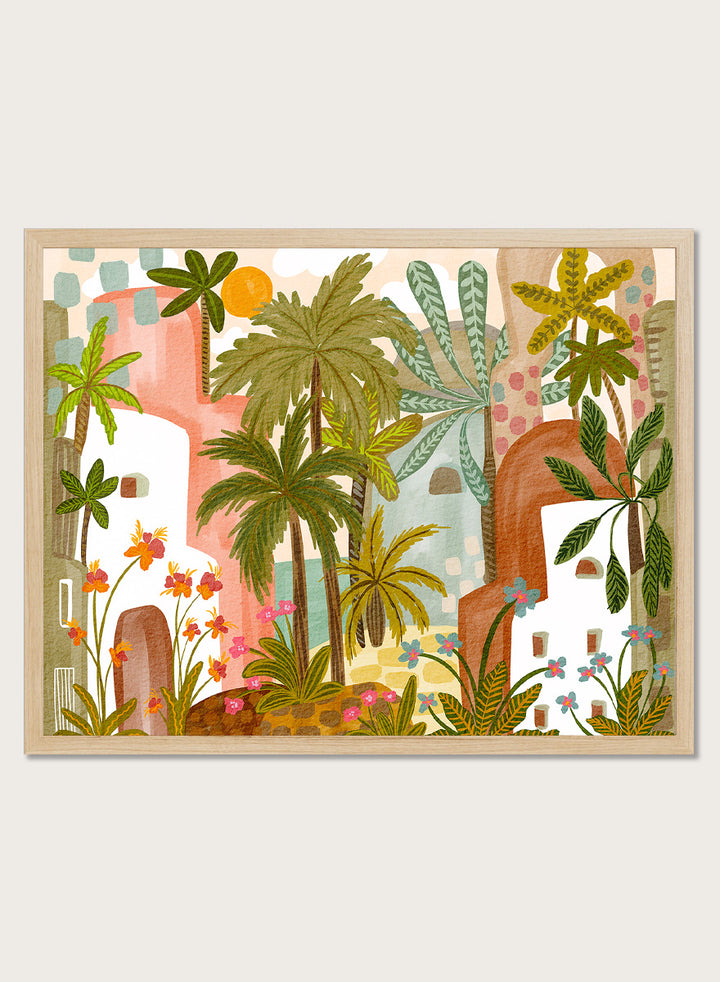 A framed art print featuring a whimsical, retro-style illustration of a tropical city with palm trees, colorful buildings, and flowers. Shop Vibrant Tropical Village by Nikita Jariwala, a tropical wall art print poster with palm trees, colorful village architecture, botanical scenery, and green tones.