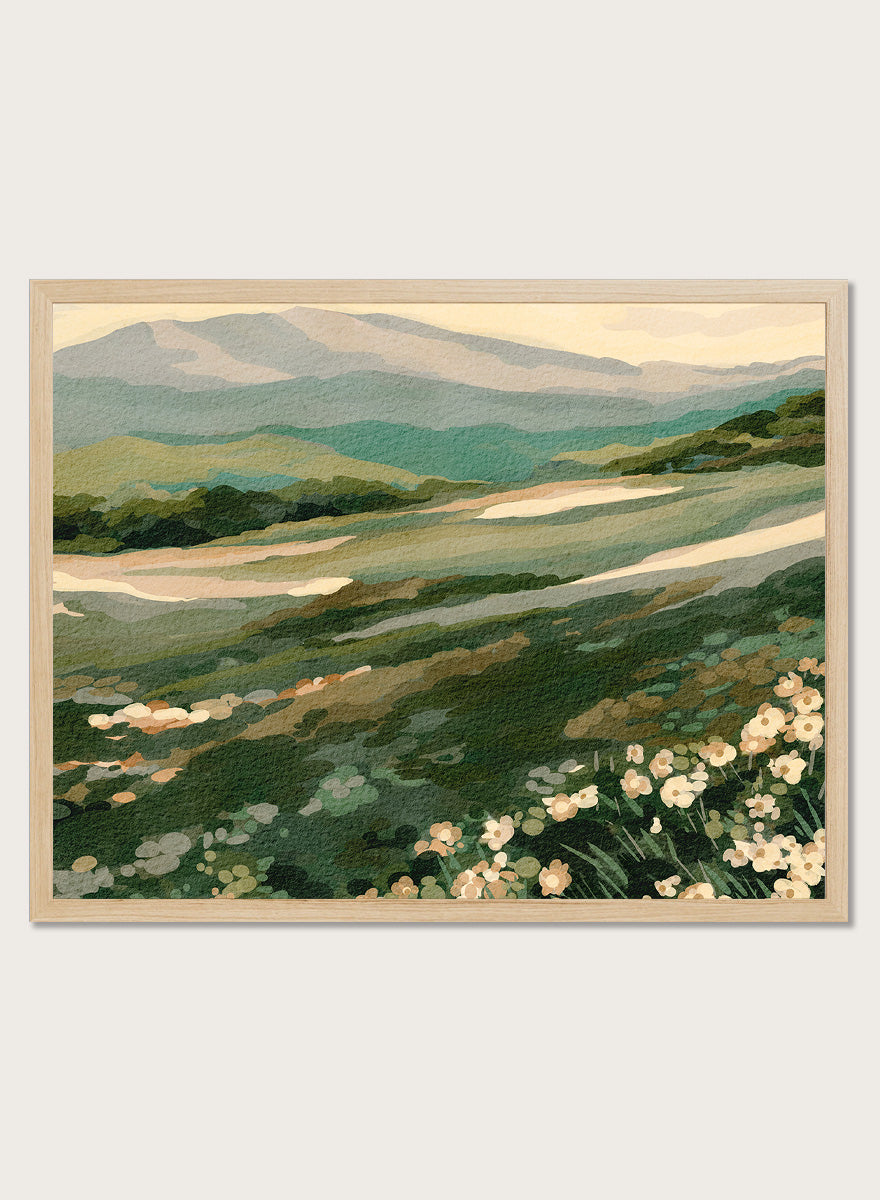 Shop Wildflower Mountain Landscape by Nikita Jariwala, a mountain wall art print with rolling green hills, cream wildflowers, and soft sage and blue-gray tones.