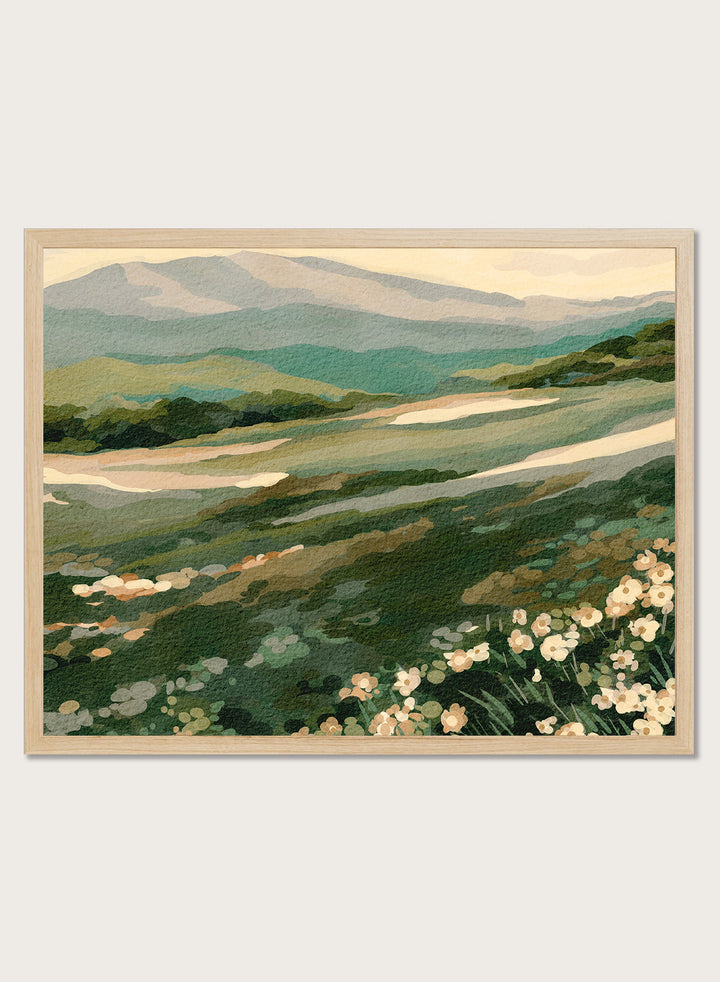 Shop Wildflower Mountain Landscape by Nikita Jariwala, a mountain wall art print with rolling green hills, cream wildflowers, and soft sage and blue-gray tones.