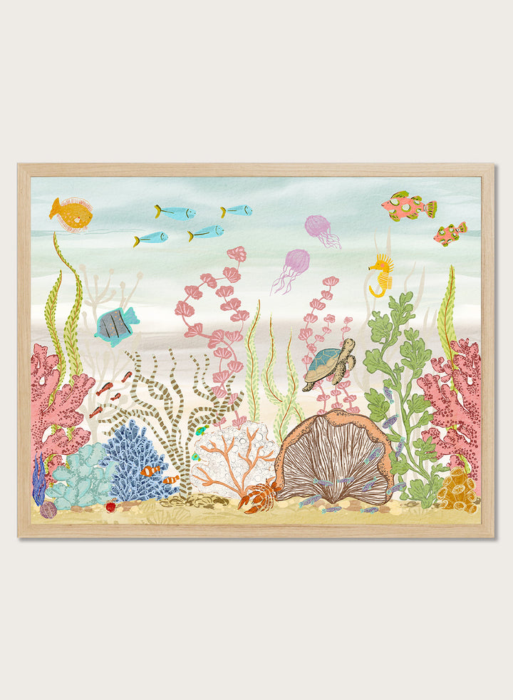 A framed art print depicting a colorful underwater scene with fish, coral, sea plants, a turtle, and a clam shell on a sandy ocean floor, shown against a light neutral background. Shop Vibrant Underwater World by Nikita Jariwala, an ocean wall art print poster with sea turtles, tropical fish, coral reef art, jellyfish, and blue tones.