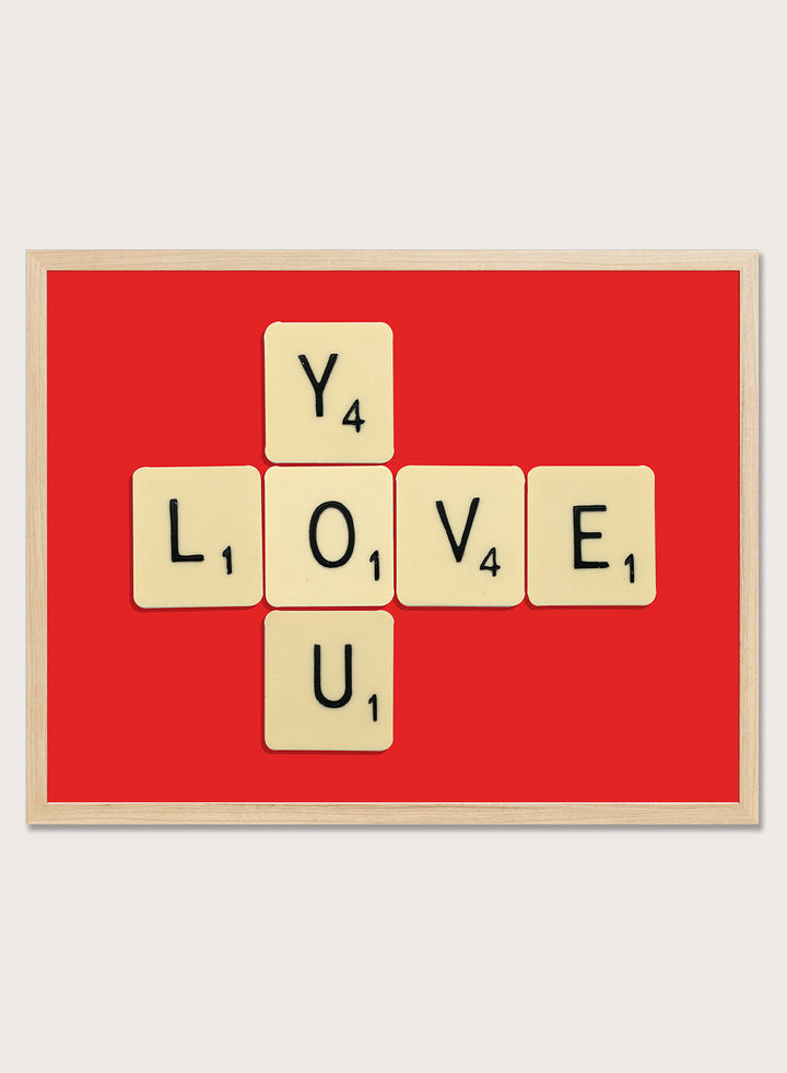 Scrabble tiles spelling LOVE YOU on a red background. Love You by Florent Bodart is a playful crossword-style art print featuring letter tiles spelling LOVE YOU on a red background. Retro typography wall poster with optional framing.
