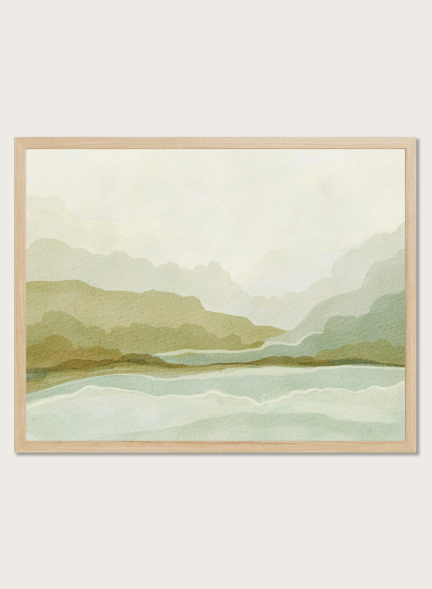 Shop Watercolor Mountain Valley Landscape by Nikita Jariwala, a mountain wall art print poster with soft green hills, blue water, and a muted watercolor palette.