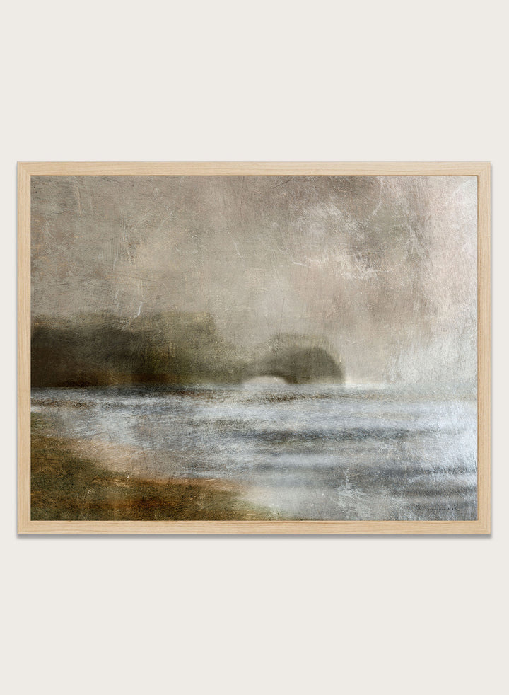 A framed abstract landscape art print featuring textured waves and a distant rocky shoreline in muted beige, gray, brown, and white tones. Shop Dusk by Dan Hobday, a moody landscape art print featuring misty water, low hills, earthy neutral toned nature, and soft layered brush texture.