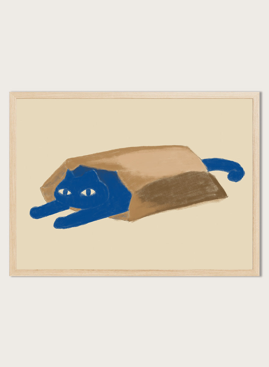 A framed art print featuring a whimsical illustration of a blue cat peeking out from inside a brown paper bag, set against a warm beige background. Blue Cat In A Bag by The Art Concept is a playful minimalist cat art print featuring a blue cat tucked inside a paper bag on a warm cream background.