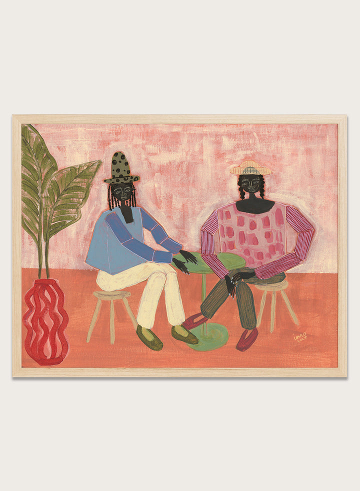 Artistic depiction of two people sitting on chairs with a plant and vase in the foreground, on a pink background. With a Friend by Studio IMO (Ibi Meier-Oruitemeka) is a modern figurative art print with two figures at a table in a contemporary wall poster design.