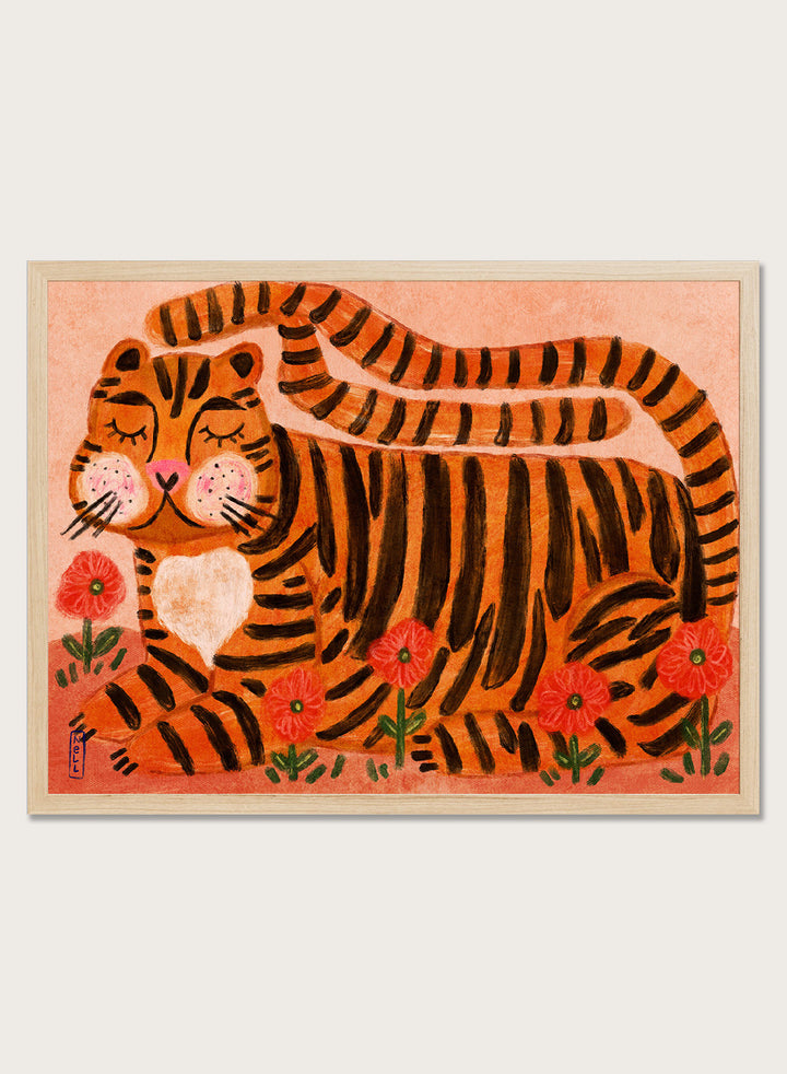 A framed art print featuring a stylized orange and black striped tiger lying among red flowers on a peach background. Playful tiger animal art print by Dirkie Nell with bold orange stripes, red poppies, and a warm peach background. Shop this cheerful piece today.