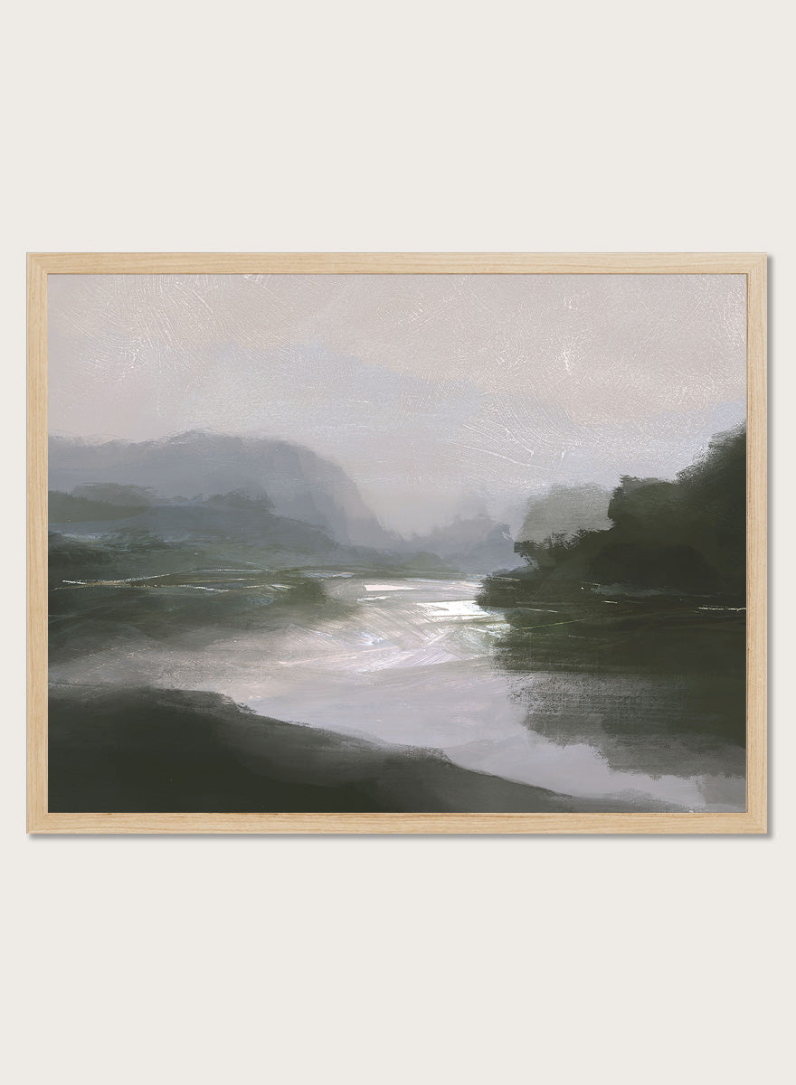 A framed landscape art print depicting a misty river scene with dark green hills, a reflective river, and a pale gray sky. Shop Tranquillitas by Dan Hobday, a contemporary landscape wall art print featuring reflective water, distant hills, dark green trees, and soft gray tones.