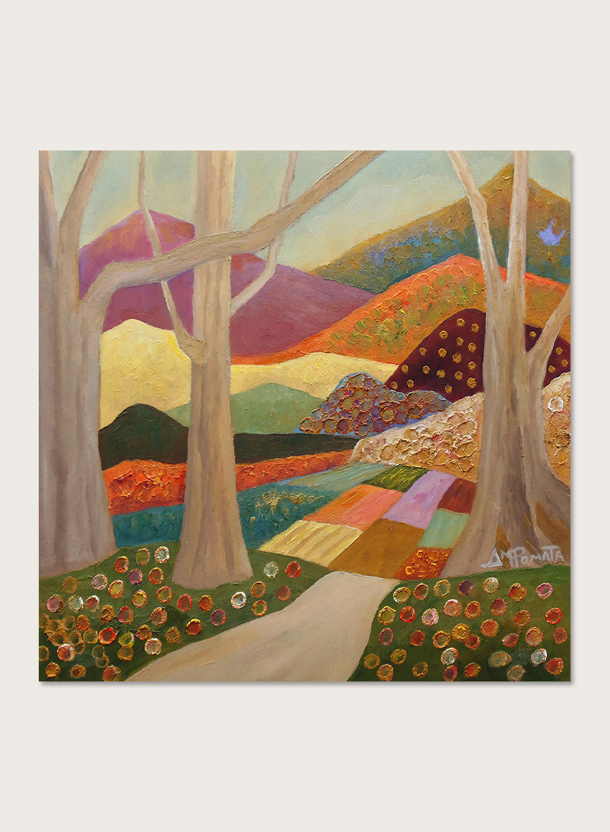 A framed landscape painting featuring stylized trees, a winding path, patchwork fields, and mountains in warm earthy tones. Shop Colorful Field Path by Angeles M. Pomata, an autumn landscape art print featuring a winding path, textured fields, flowers, and rolling countryside.