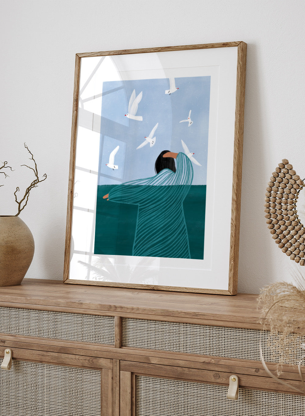 Seaside Serenity by Bea Müller is an officially licensed art print featuring a calm seaside figure and flying birds. Available as fine art print or framed with real wood frames.